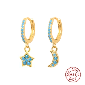 Detailed close-up of S925 sterling silver gold hoops with blue star and moon charms