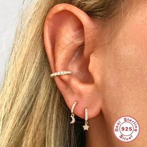 Gold S925 sterling silver star and moon earrings set with pavé diamonds on model