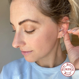 Elegantes pendientes de estrella de plata S925 con cadena de borlas en una modelo