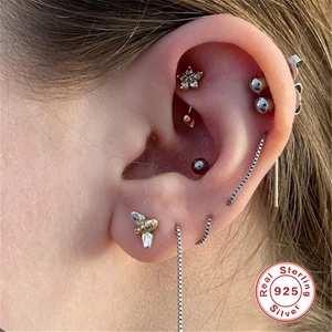 Detail of S925 sterling silver bee stud and ear chain on ear for multiple piercings