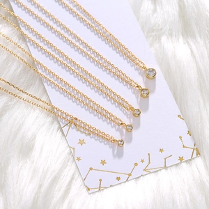 Detailed view of dainty gold-plated O-chain necklaces with round solitaire pendants