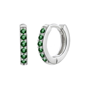 Macro view of silver huggie earrings with inset green zircon stones on white background