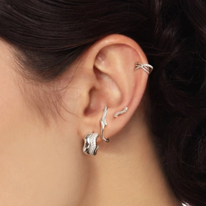 Close-up of S925 silver crossover ear cuffs and studs with sparkling zircon stones