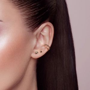 Close-up of S925 silver double-layer ear cuff set with black diamonds and gold studs