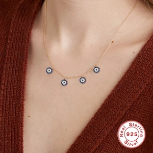 Elegant S925 sterling silver evil eye necklace with five blue stones worn on neck
