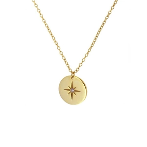 Macro shot of gold octagonal star pendant necklace with central cubic zirconia detail