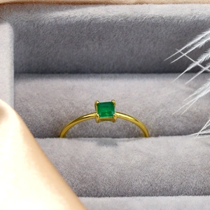 Luxury S925 emerald cut green gemstone wedding ring with minimalist gold band on silk