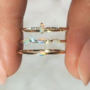 Macro detail of three stacked S925 silver rings with marquise opal and zircon stones