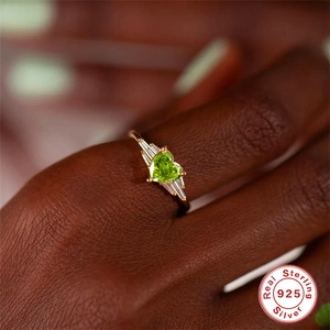 Macro view of a heart-cut emerald gemstone ring in gold-plated sterling silver