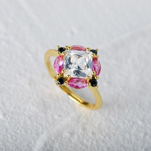 Macro detail of gold S925 silver ring with square clear stone and pink marquise accents