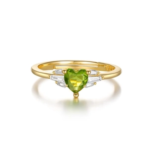 Macro detail of S925 silver gold-plated ring with heart-shaped green gemstone