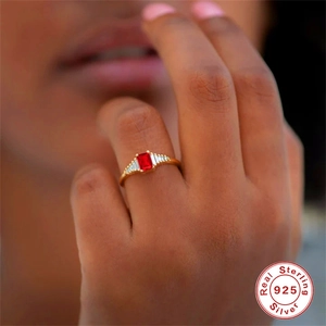 Luxurious S925 sterling silver ring with oval red gemstone and white side stones