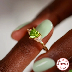 Luxurious S925 sterling silver ring with heart-shaped green gemstone on a model hand