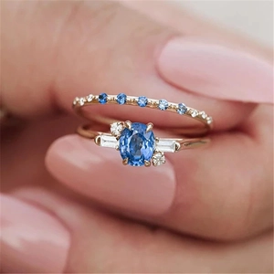 Macro shot of double-layered S925 silver rings with blue gemstone and pavé diamonds