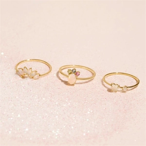 Detailed view of three gold-plated rings featuring white opal and colorful gemstones