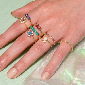 Macro view of S925 silver double-layer rings with colorful gemstones and pavé diamonds