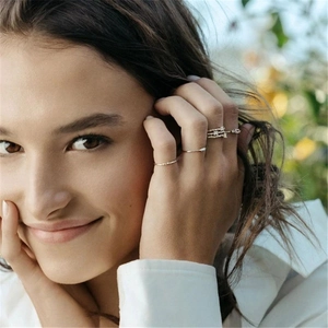 Close-up of stacked S925 sterling silver double-layer diamond rings on a model hand
