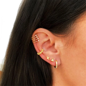 Close-up of layered S925 silver gold earrings with zircon studs and ear cuffs on model