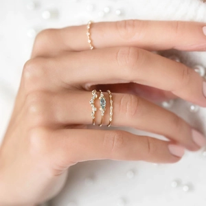 Detailed view of stacked S925 silver rings with marquise blue sapphire and gold plating