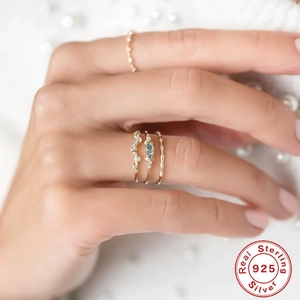 Set of four S925 sterling silver rings with blue marquise gem and micro pave diamonds