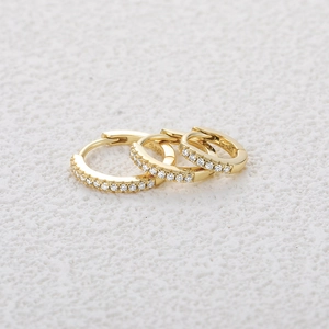 Detailed macro view showing three sizes of gold S925 silver hoop earrings with moissanite