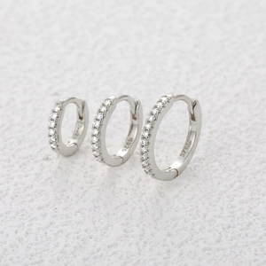 Macro shot of S925 sterling silver hoop earrings set with small moissanite stones