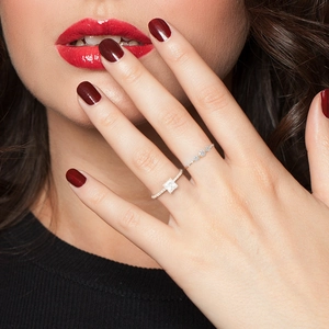 Close-up of stacked S925 silver rings with square princess cut zircon on model hand