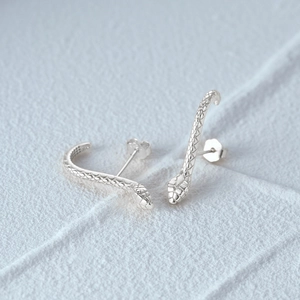 Macro shot of S925 sterling silver snake stud earrings with detailed scale textures
