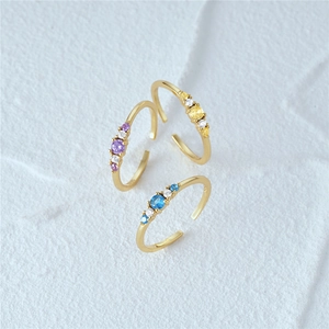 Detail of adjustable S925 silver gold-plated rings set with colorful zircon gemstones