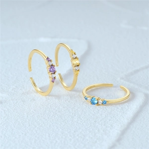 Detail of three S925 sterling silver adjustable rings with colorful center stones