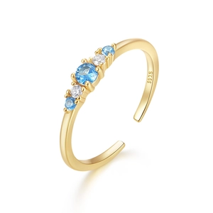 Detailed macro of S925 silver ring with blue center stone and gold plated finish
