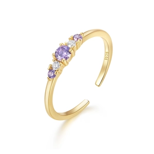 Detailed macro of S925 sterling silver gold ring with purple and white cubic zirconia