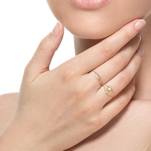 Close-up of minimalist gold s925 silver leaf rings with zircon stones on model hand
