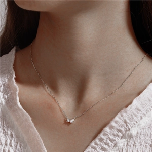 Detailed close-up of a minimalist S925 silver necklace with two pear-shaped zircon stones