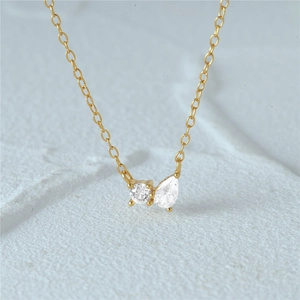 Detail of 925 silver gold-plated necklace with round and pear-cut zircon stones