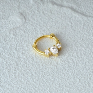 Macro detail of gold S925 silver clicker ring featuring triple marquise cut white opal gems