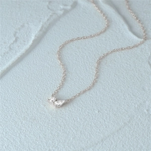Detail view of S925 sterling silver necklace with teardrop zircon pendant on stone