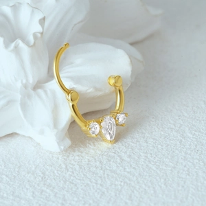Macro detail of gold S925 silver clicker hoop featuring three sparkling marquise zircons