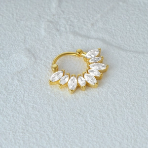 Macro view of gold plated marquise cut opal cartilage hoop with sparkling cubic zirconia