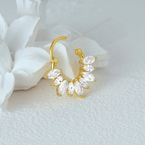Macro shot of S925 sterling silver gold nose ring with marquise-cut zircon stones
