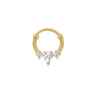 Detailed close-up of golden septum ring featuring a pear-cut center stone and side gems