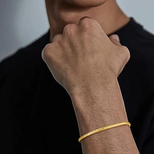 Close-up of a men's gold S925 sterling silver snake chain bracelet on a model wrist