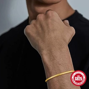 Classic 925 sterling silver snake chain bracelet in gold finish worn by a male model
