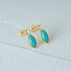 Detail of marquise turquoise stud earrings with sparkling cubic zirconia on gold base