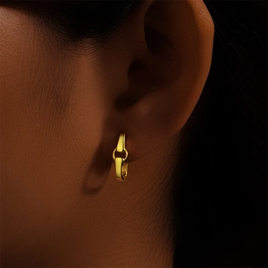 Close-up of polished 18K gold-plated S925 sterling silver hoop earring on ear