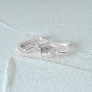 Macro shot of silver S925 sterling silver rectangular earrings with interlocking circles