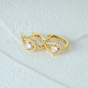 Detailed close-up of S925 silver gold-plated halo hoop earrings with cubic zirconia