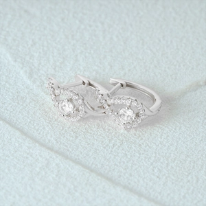 Macro shot of 925 sterling silver infinity hoop earrings with sparkling zircon stones