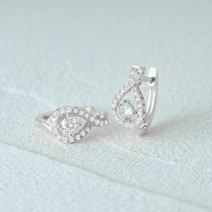 Close-up of 925 sterling silver figure-eight hoop earrings with sparkling pavé zircon stones