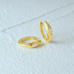 Detail of 18K gold-plated hoop earrings featuring a micro-pave zircon starburst design
